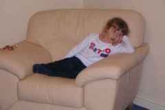Megan, a tired little girl in a big chair